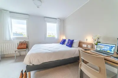 Un ou plusieurs lits dans un hébergement de l'établissement Montempô Appart'hôtel Lyon Viviani