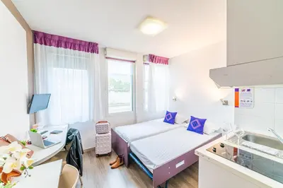 Un ou plusieurs lits dans un hébergement de l'établissement Montempô Appart'hôtel Lyon Viviani