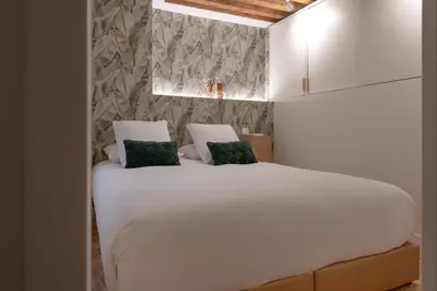 Un ou plusieurs lits dans un hébergement de l'établissement MiHotel Georges