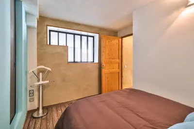 Un ou plusieurs lits dans un hébergement de l'établissement Appartement Le Cosy - Calme & Chaleureux - Bien situé