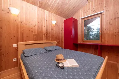 Un ou plusieurs lits dans un hébergement de l'établissement Camping Le Lac des Sapins