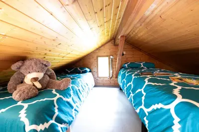 Un ou plusieurs lits dans un hébergement de l'établissement Camping Le Lac des Sapins