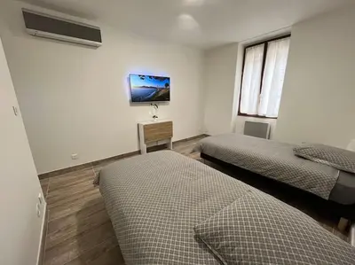 Un ou plusieurs lits dans un hébergement de l'établissement Superbe appartement à 15 min de Lyon